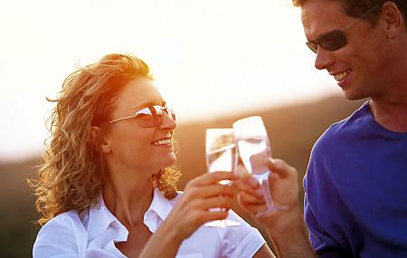 Couple relax with a glass of Wine at sunset One Mile Beach, Anna Bay, Port Stephens North Coast NSW
